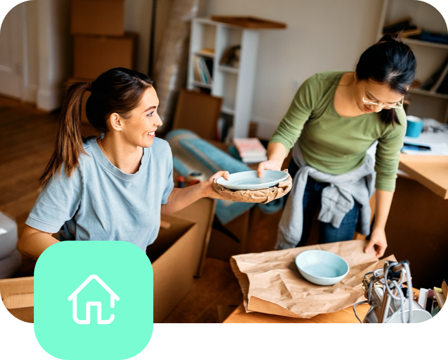 IncomeProtection_Image 2 woman smiling and packing plates for moving