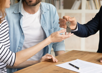 Couple receiving their keys from an estate agent