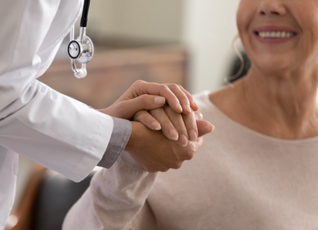 illness Doctor holding patients hand